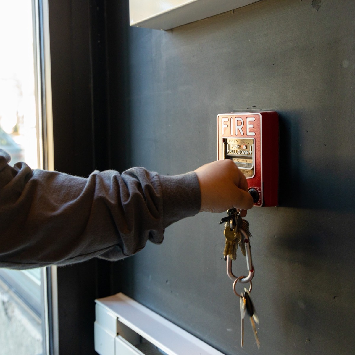 Technician at a fire alarm pull station