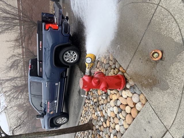 Private hydrant flowing through a pitot diffuser at a retail center, First Response truck behind